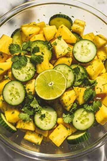 Pineapple cucumber salad in a glass bowl