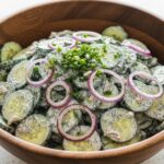 high protein cucumber salad in wooden bowl with dill and red onion