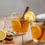 lemon ginger cinnamon tea in mugs with lemon and honey