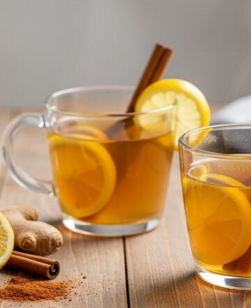 lemon ginger cinnamon tea in mugs with lemon and honey