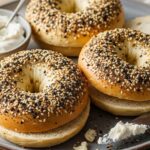 Plate of warm cottage cheese bagels sliced open