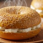 Freshly baked protein bagel sliced with cream cheese