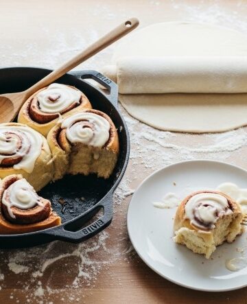 slicing sourdough discard cinnamon roll dough on floured counter