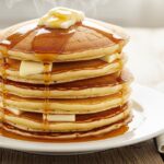 Fresh stack of Bisquick pancakes with syrup and butter
