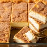 sliced churro cheesecake bars with golden cinnamon topping