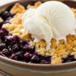 warm blueberry crumble with vanilla ice cream