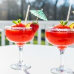 frozen strawberry margaritas with umbrellas and strawberries