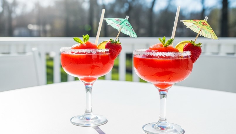 frozen strawberry margaritas with umbrellas and strawberries