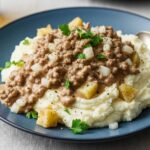 Final hamburger gravy dish over mashed potatoes